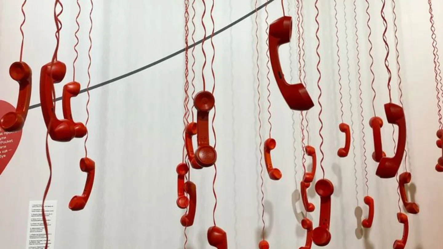 Installation of red telephone handsets hanging on cords, representing events and experiential marketing at Growth Yogi